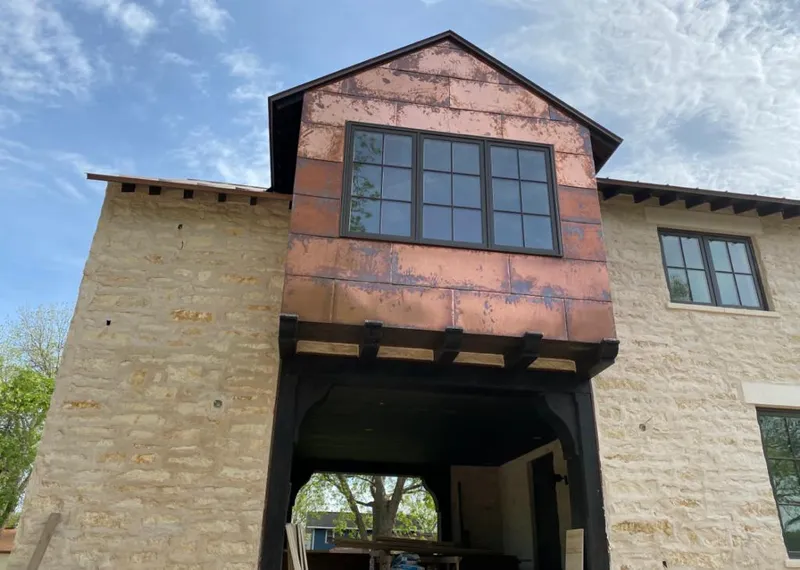 Copper metal panel facade on a stone building for Skylight Installation in Kansas City