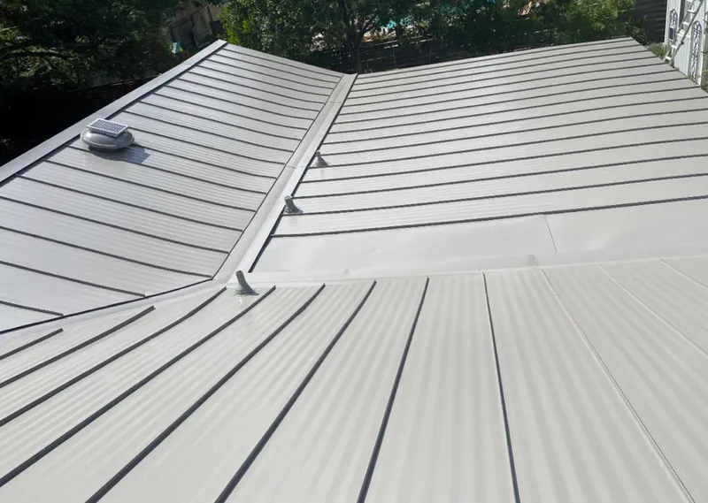 Solar attic fan installed on a metal roof for Roof Ventilation in Kansas City